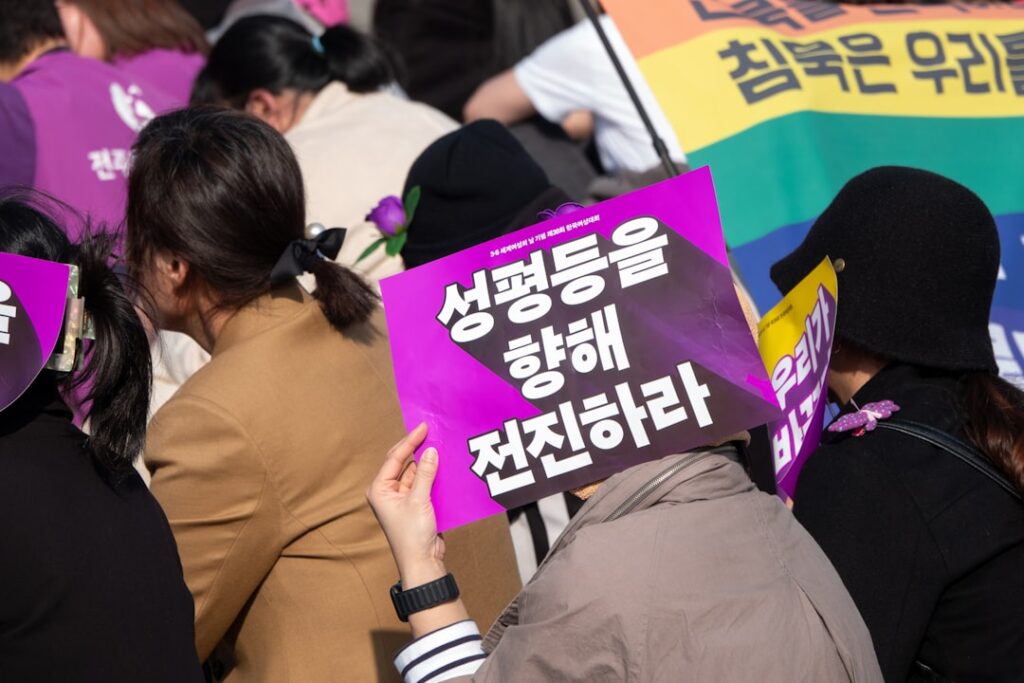 A group of people holding signs and wearing masks