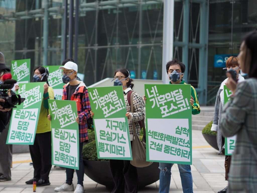 men and women holding board signs in a rally
